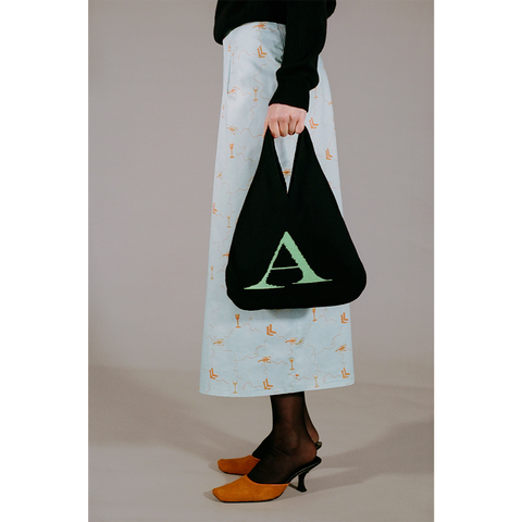 Model holding the HADES wool Letter A bag 