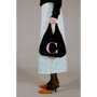 Model holding the HADES wool Letter C bag