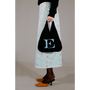 Model holding the HADES wool Letter E bag