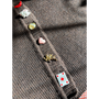 Close-up of a wool cardigan with colorful buttons on a white background