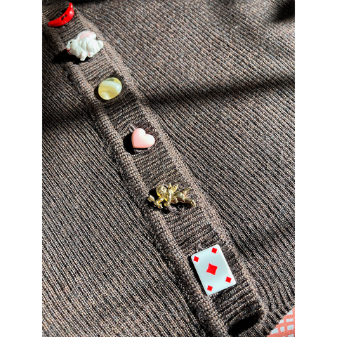 Close-up of a wool cardigan with colorful buttons on a white background