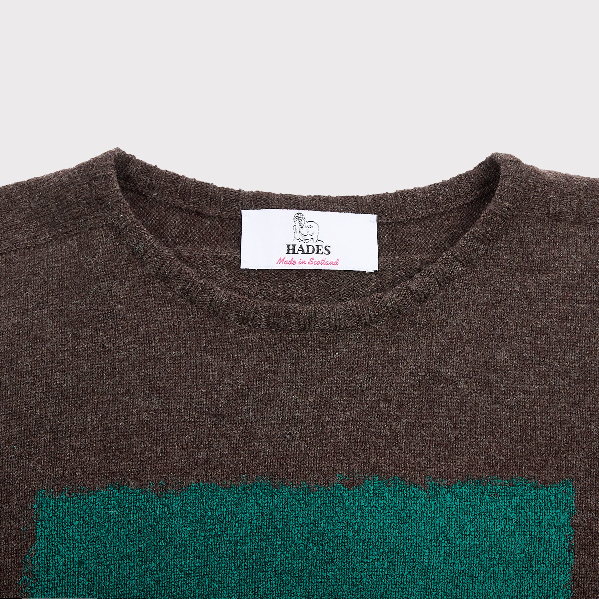 Detail flatshot of neckline and label on Gesture knit.