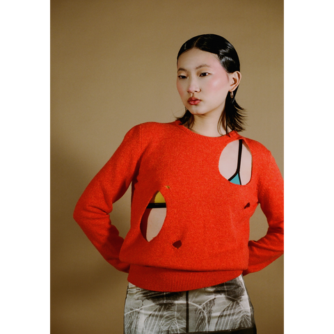 Upclose shot of the orange Selavy jumper from the DADA Collection