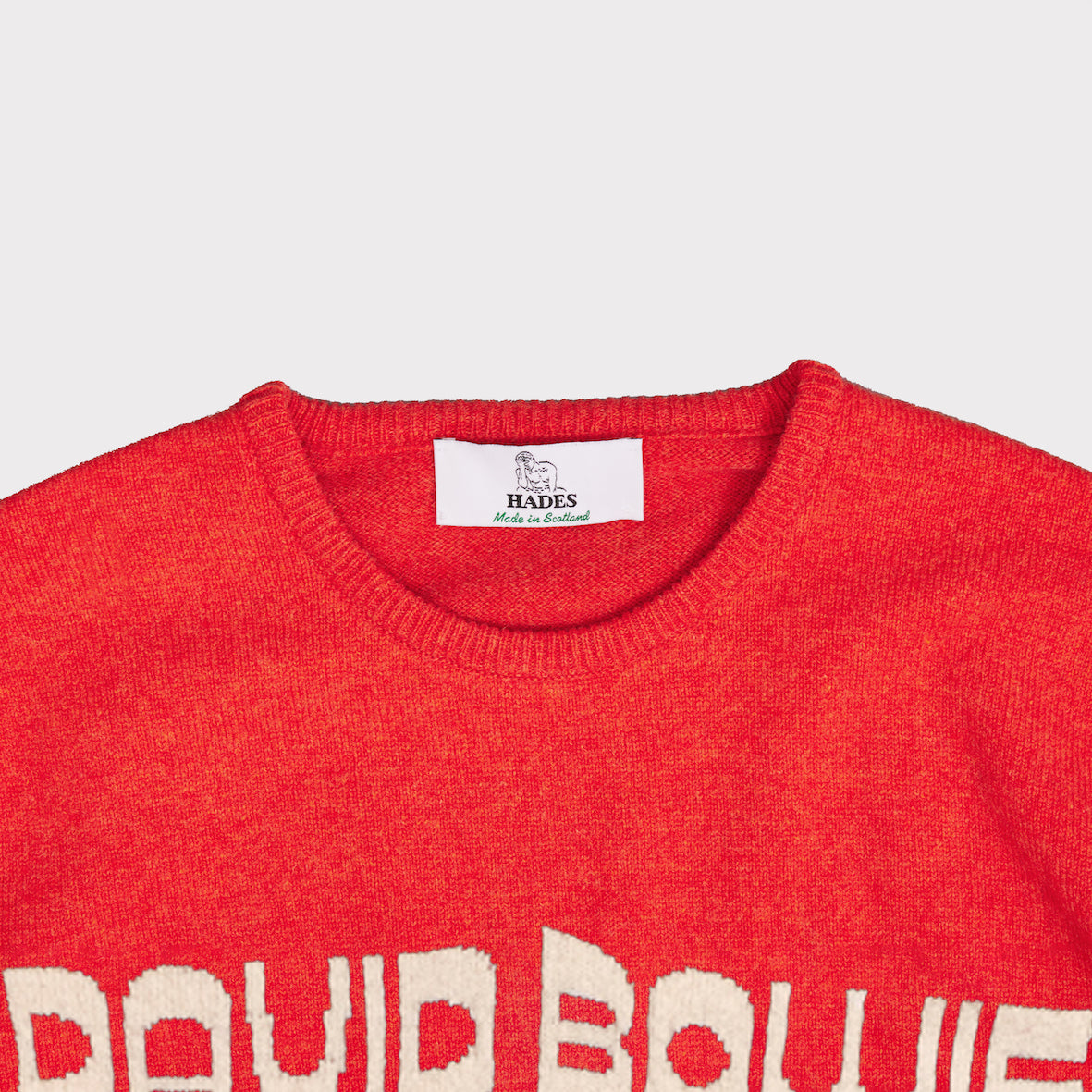 Up close shot of the neckline on the orange and oatmeal men's 'Hunky Dory' David Bowie jumper