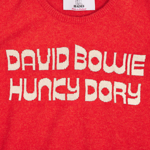 Up close shot of the text from the orange and oatmeal women's 'Hunky Dory' David Bowie jumper