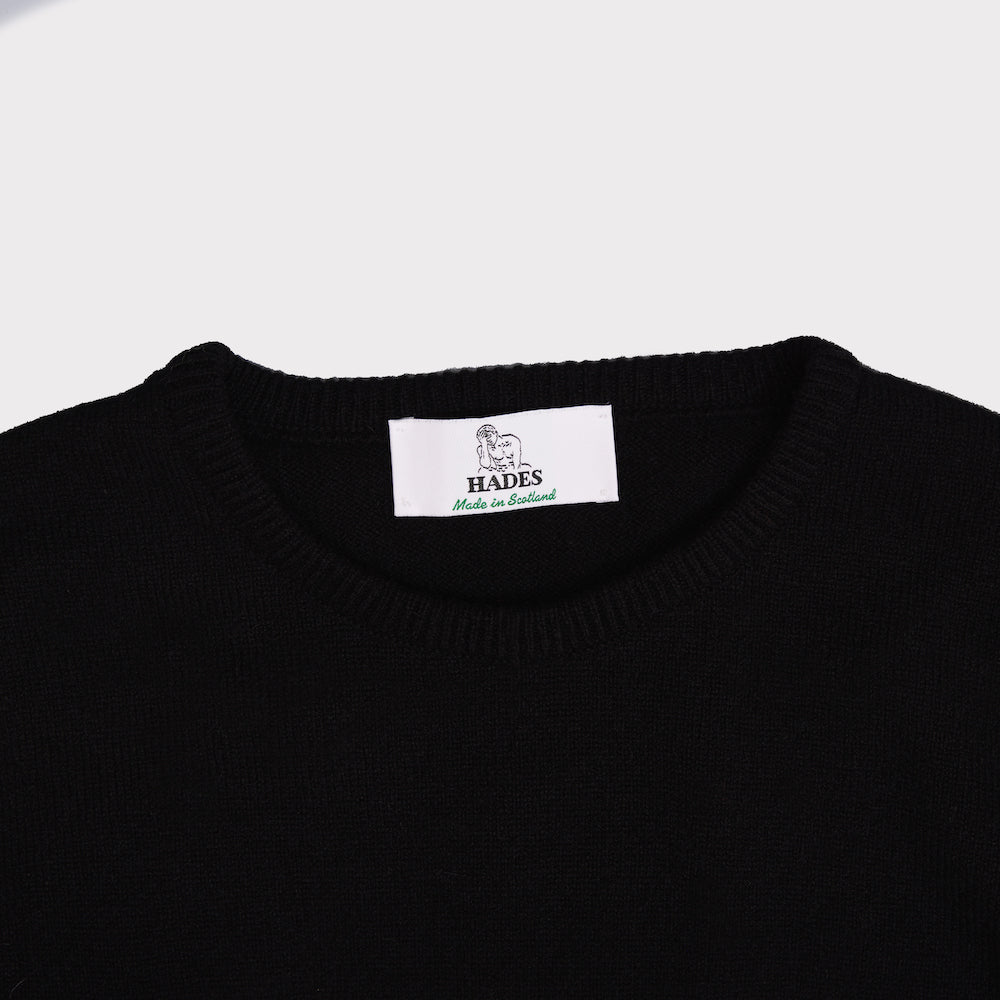 Up close shot of the neckline of the men's black and white 'The man who sold the world' David Bowie jumper