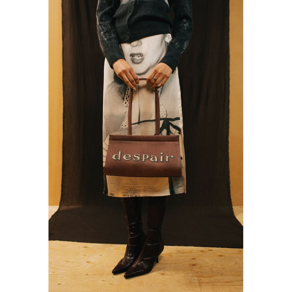 A model wearing the HADES Despair Bag 