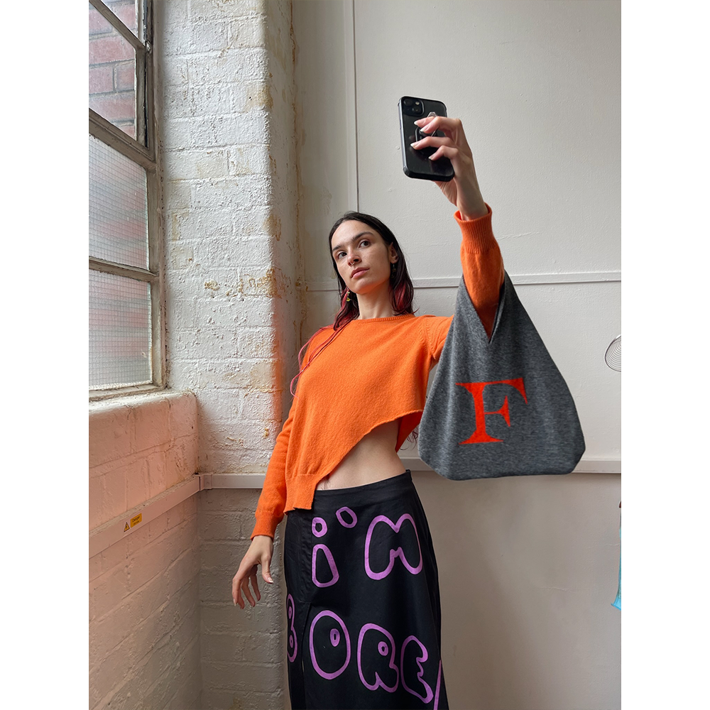 Model wearing HADES F bag taking a selfie