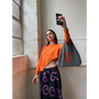 Model wearing HADES F bag taking a selfie
