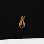 Up close shot of the K gold plated button featured on the FU*K Carrington cardigan