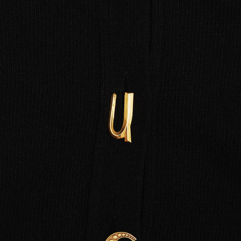 Up close shot of the U gold plated button featured on the FU*K Carrington cardigan