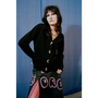 Person wearing a black cardigan and colourful skirt with 'BORED' text against a blue background