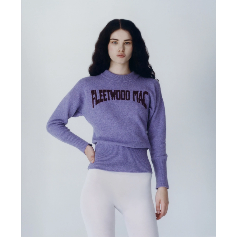 A model wearing the purple Albatross Knit from the Fleetwood Mac Collection, paired with white tights. 