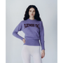 A model wearing the purple Albatross Knit from the Fleetwood Mac Collection, paired with white tights. 