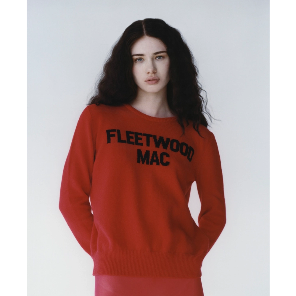 A model wearing the red Fleetwood Mac knit paired with red tights. 