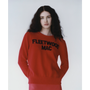 A model wearing the red Fleetwood Mac knit paired with red tights. 