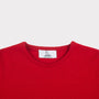 Close-up of a bright red crewneck jumper showing the inner neck label which reads 'HADES Made in Scotland'.