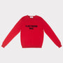 A bright red crewneck jumper with 'FLEETWOOD MAC' knitted in black across the chest, displayed flat against a light grey background.