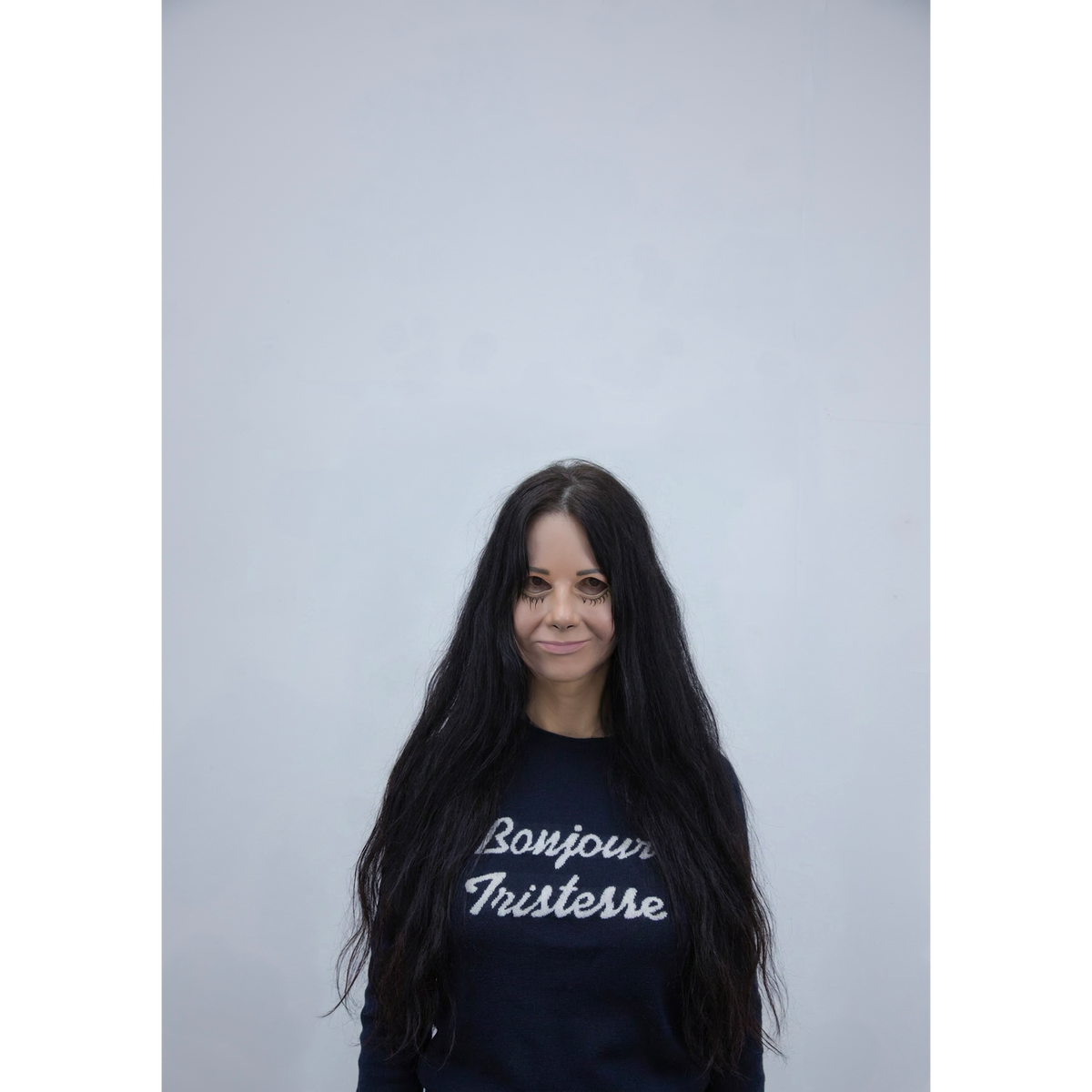 Artist Gillian Wearing wearing a navy knit jumper.