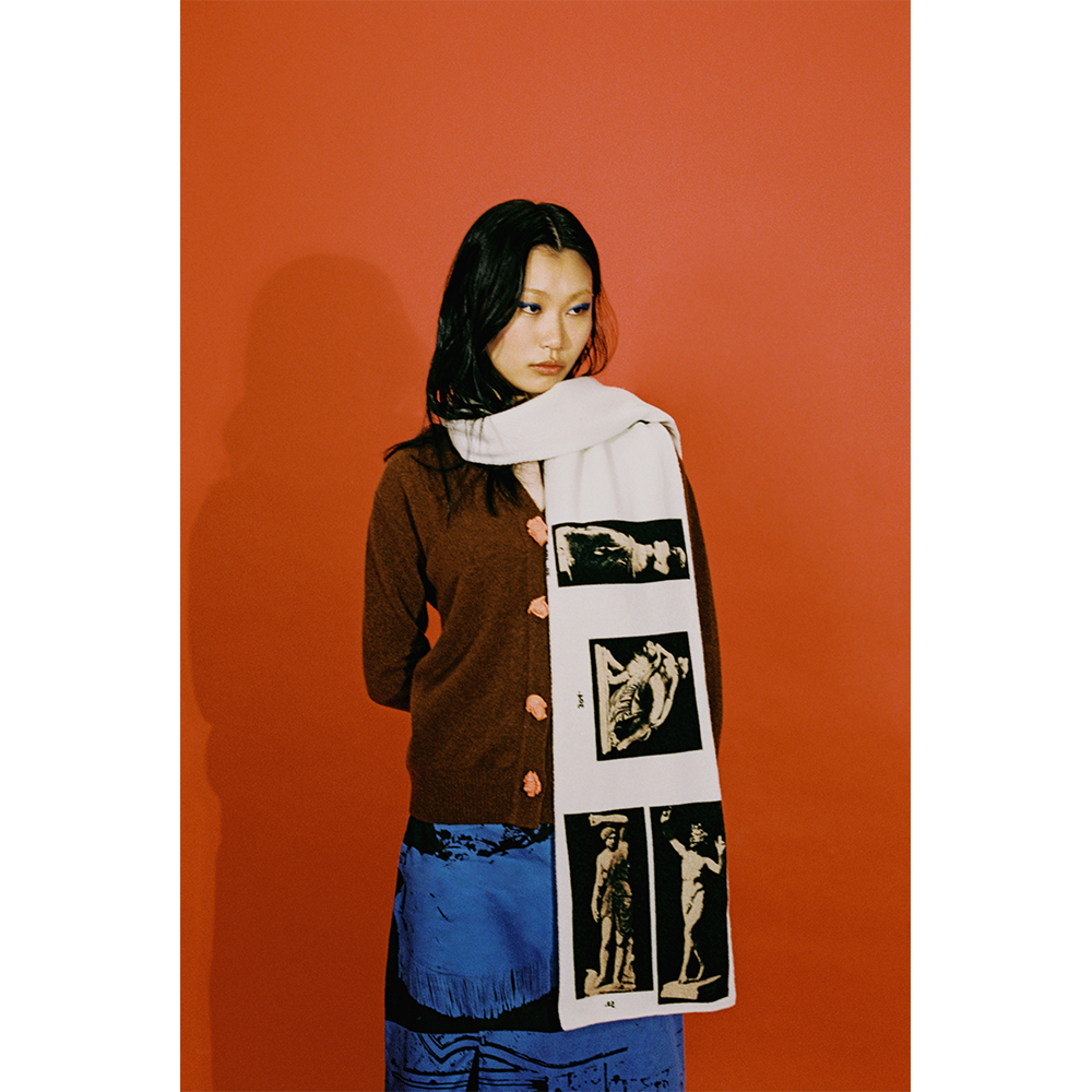 Model wearing the HADES Narcissus scarf in Ivory and Black