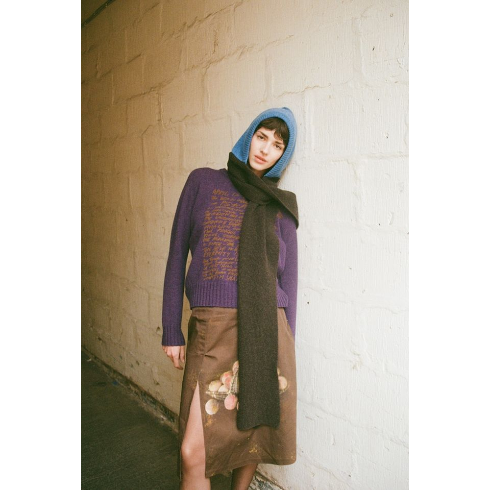 Person wearing HADES blue & brown Hooded Scarf, HADES Peaches skirt and Eternity Knit
