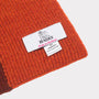 The forest, burnt orange & burgundy hooded scarf tag detail