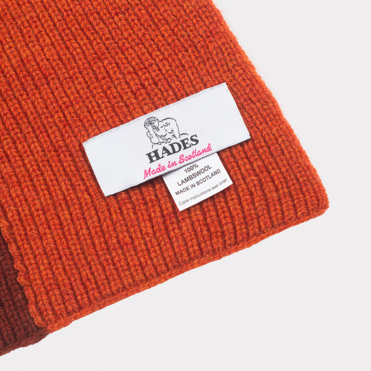 The forest, burnt orange & burgundy hooded scarf tag detail