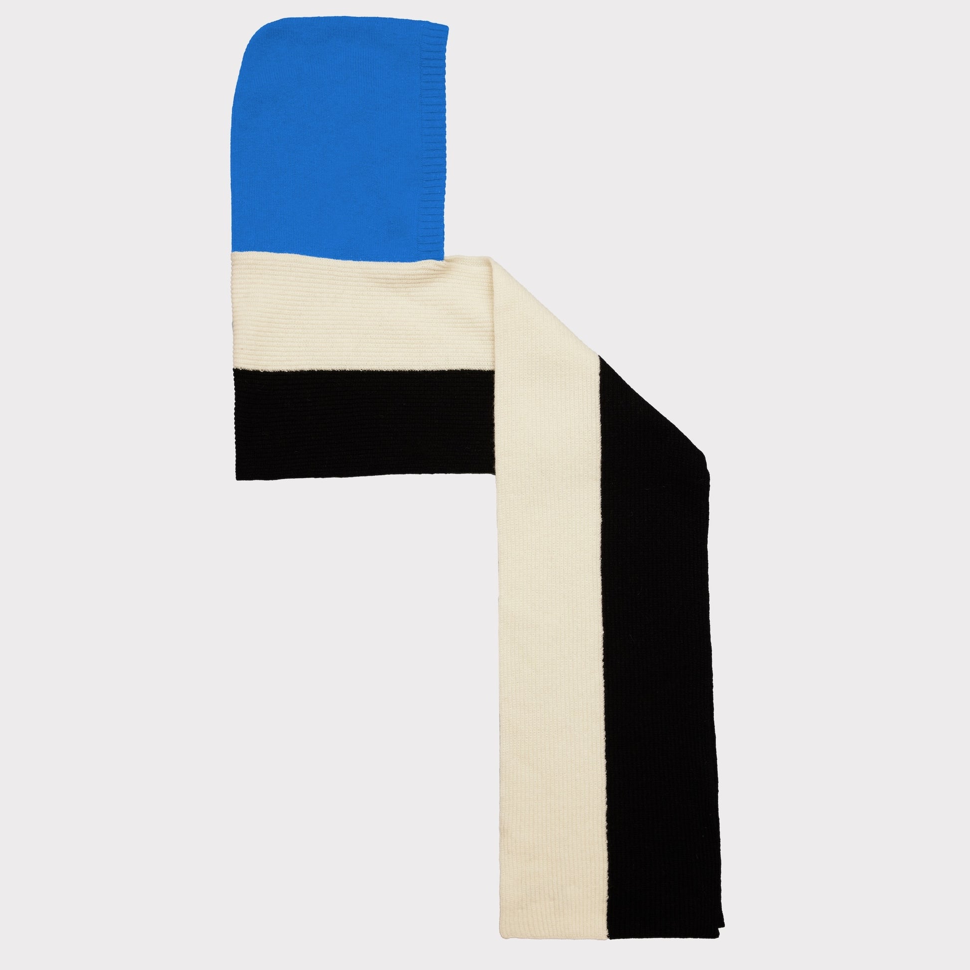 A knit scarf with a geometric color-blocked pattern featuring bright blue, cream, and black stripes, displayed against a light gray background.