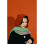 Model in HADES red hooded scarf