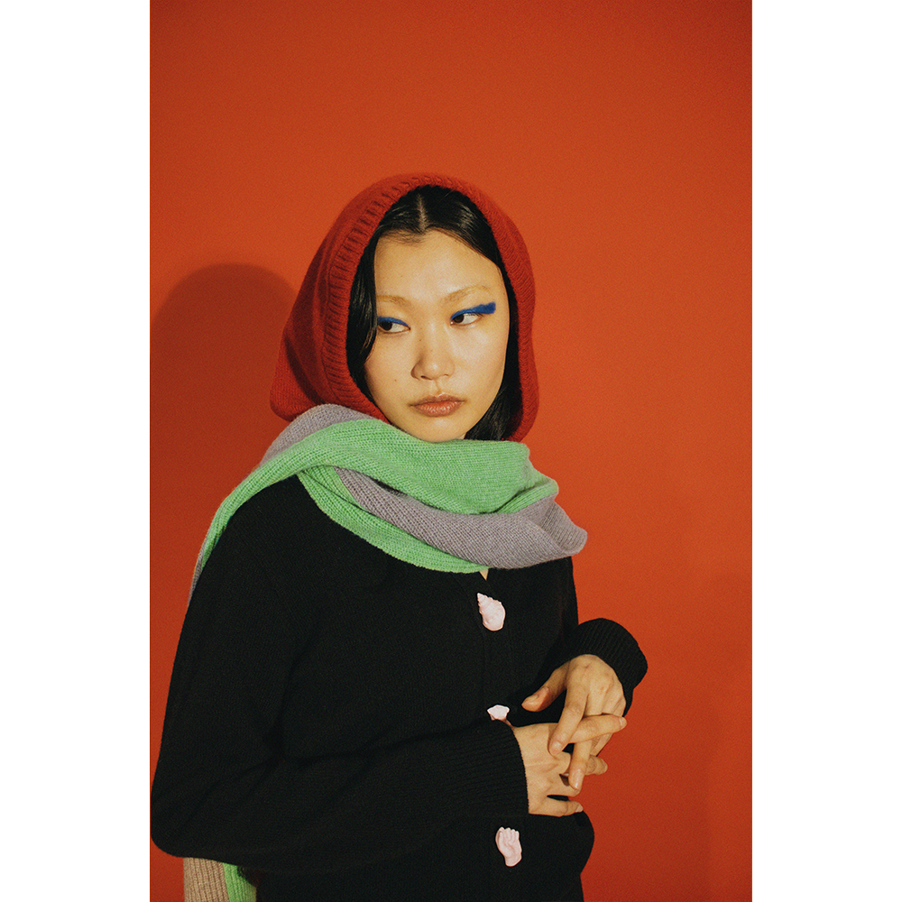 Model wearing HADES red hooded scarf