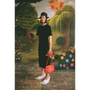 Model wearing the Dear Fellow Humans" dress in front of a faux garden of eden backdrop.