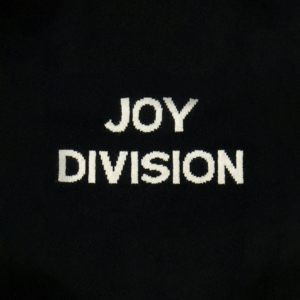 Close-up of knit  text reading 'JOY DIVISION'.