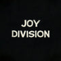 Close-up of knit  text reading 'JOY DIVISION'.