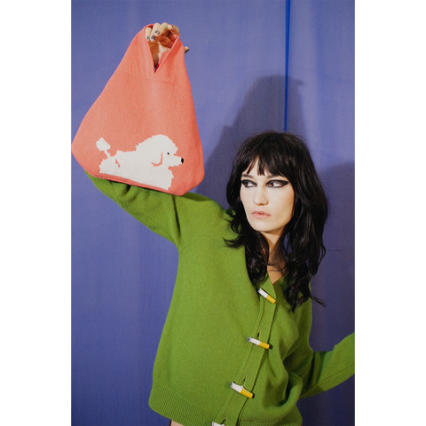 Model holding HADES Poodle Bag
