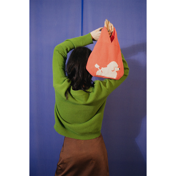 Model holding HADES Poodle Bag