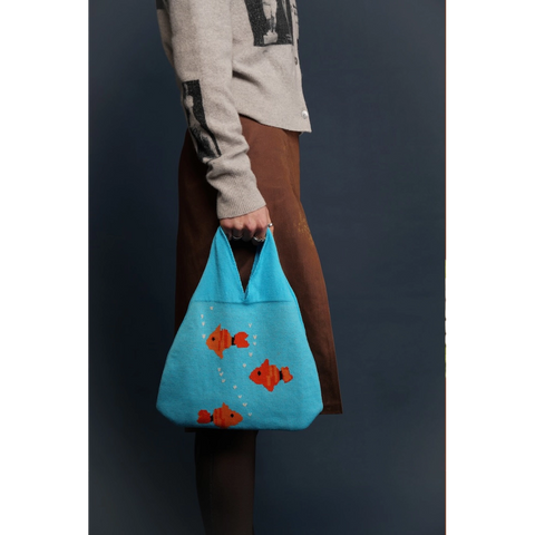 Model holding the Fishbowl Bag