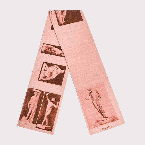 Pink scarf with vintage-style prints of statues and figures on a light pink background