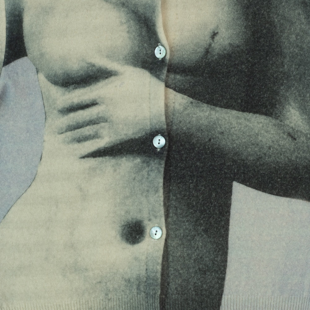 Close-up of a person wearing a buttoned cardigan