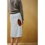 Close up of a lady wearing the Iron Burn skirt against a wooden backdrop 