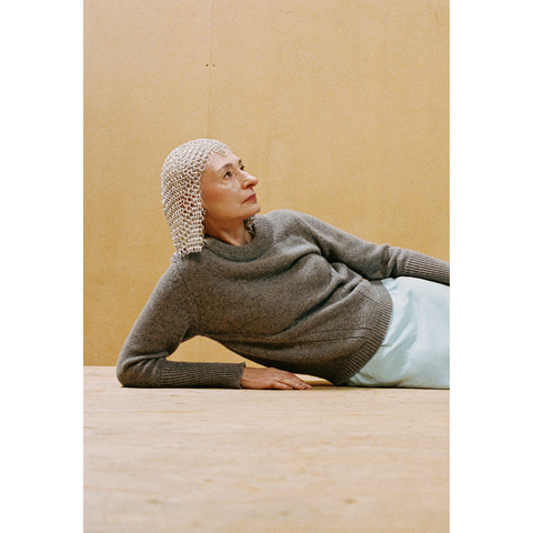 Lady laying down wearing the Armour Knit and chainmail headpiece