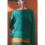 Model wearing HADES jade Manifesto Jumper against door