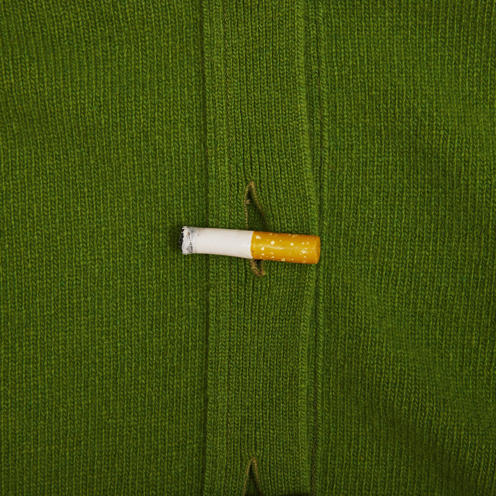 Close up shot of the button detail on the green Cigarette Carrington cardigan.