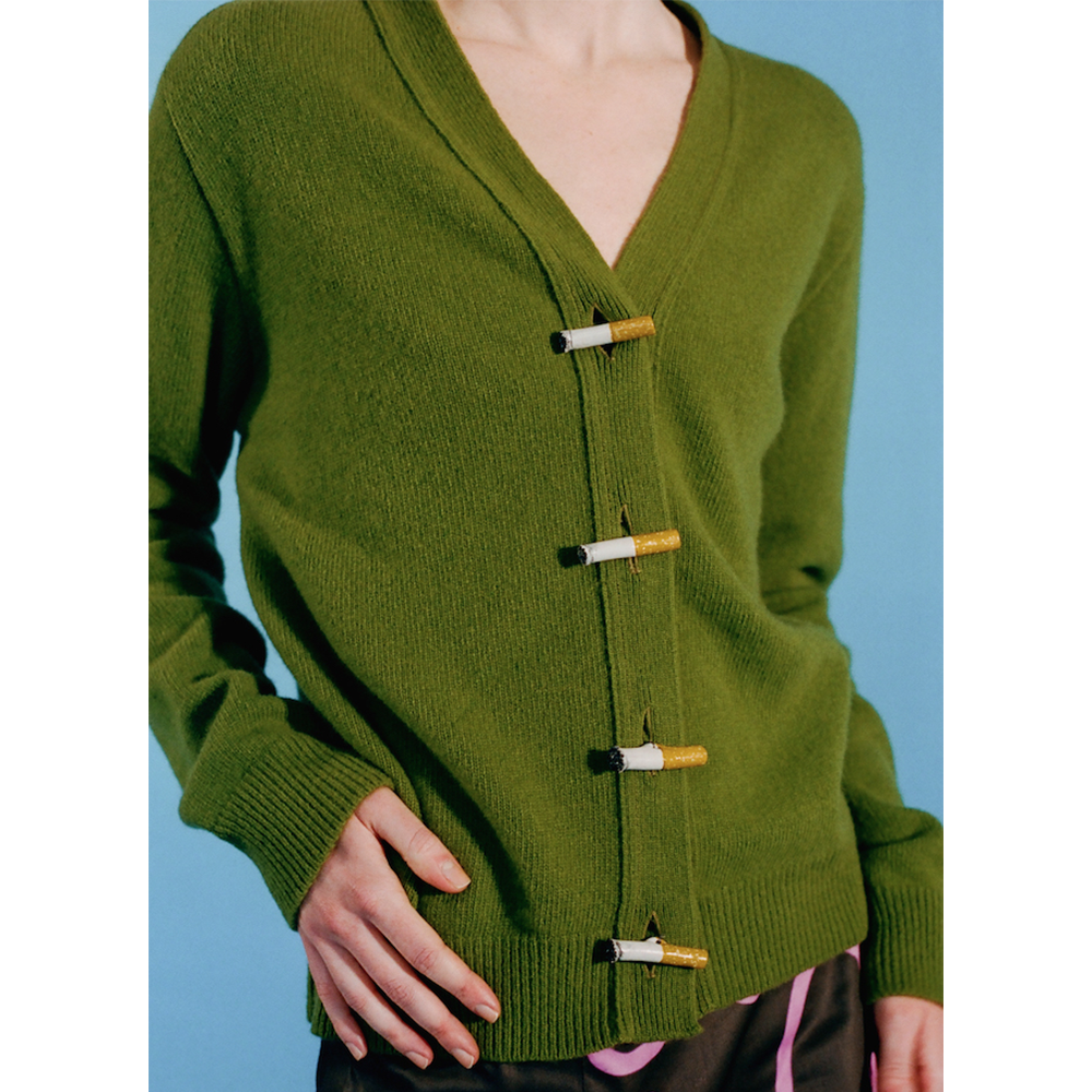 Model wearing the Cigarette Carrington cardigan in green.