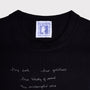 Close up flatshot of the "Dear Fellow Humans" dress and Tilda Swinton label.