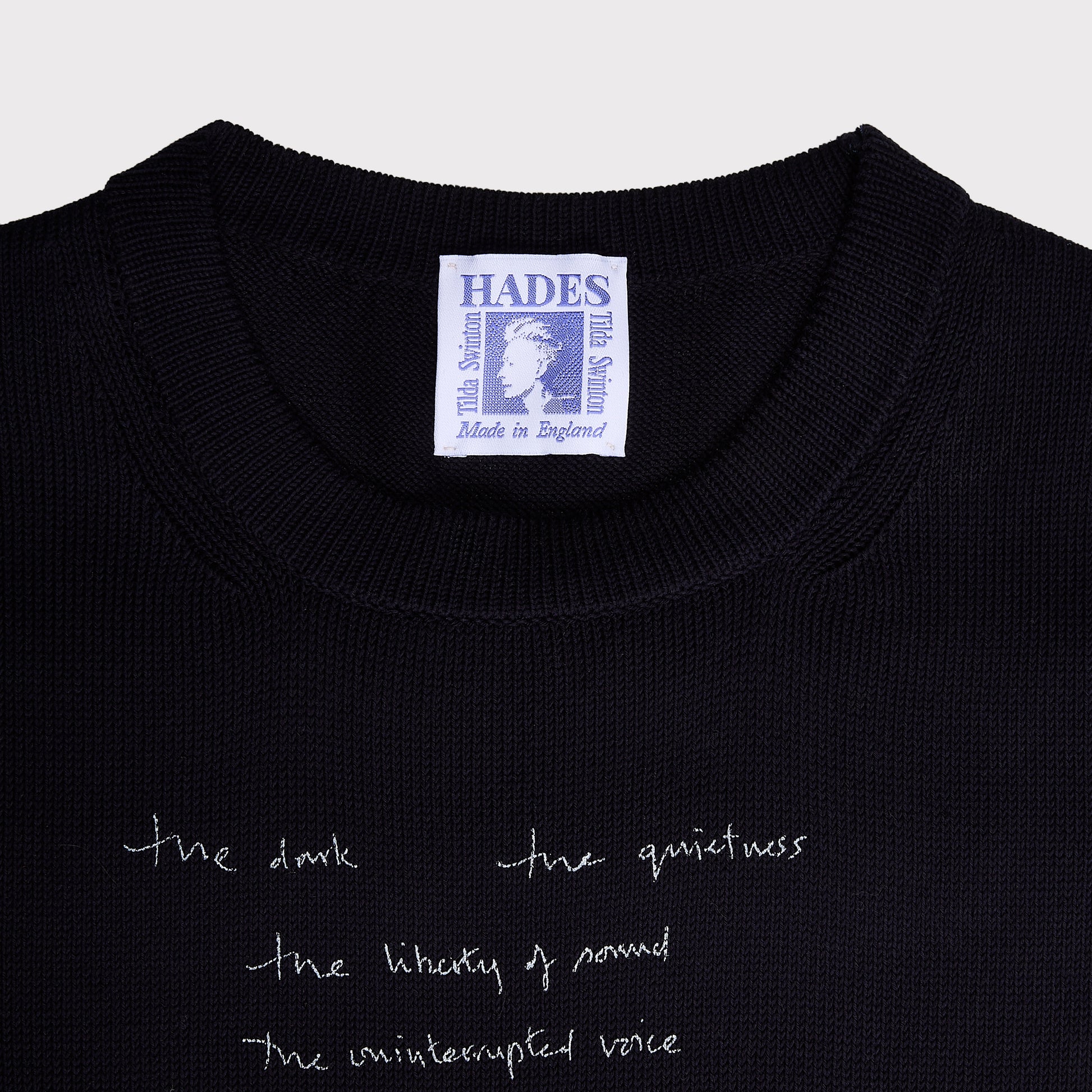 Close up flatshot of the "Dear Fellow Humans" dress and Tilda Swinton label.