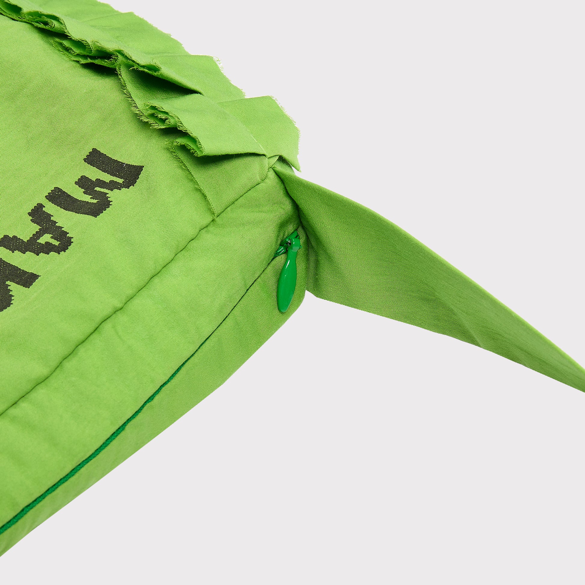 Close up flatshot of the "Make Friends With Chaos" bag zip and strap.