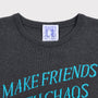 Close up flatshot of the "Make Friends With Chaos" knit in grey and Tilda Swinton label.