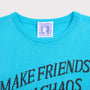 Close up shot of the "Make Friends With Chaos" knit and Tilda Swinton label. 