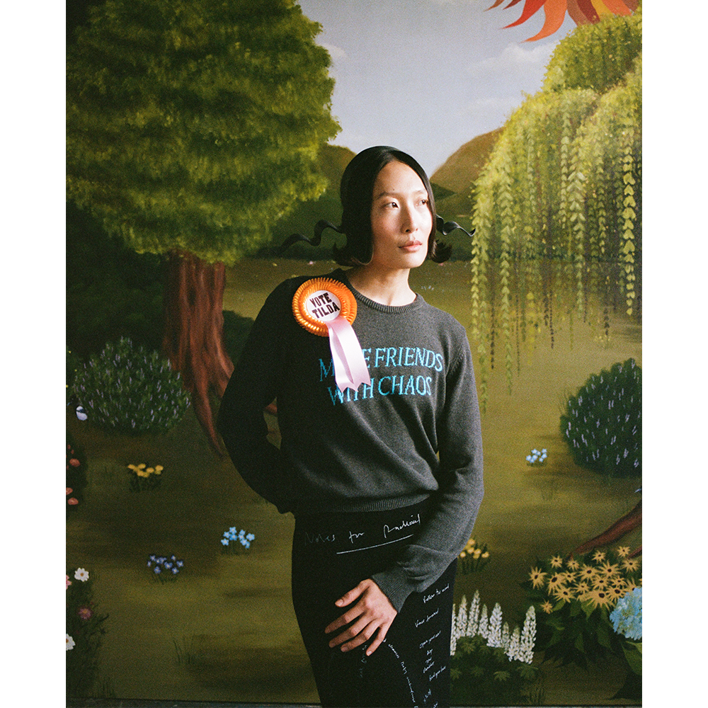 Model wearing Make Friends With Chaos jumper and VOTE TILDA rosette