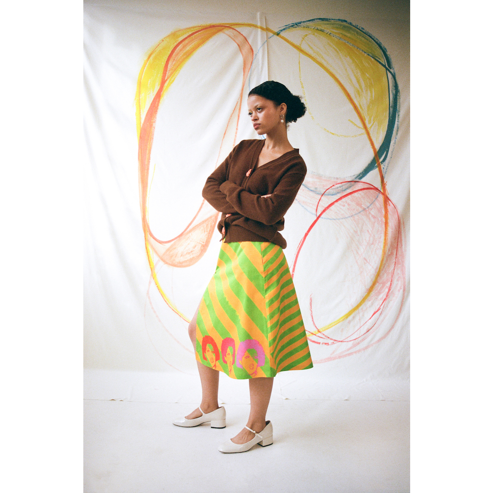 Model wearing the 'Day-Glo' skirt styled with the Greek Mythology Carrington cardigan in brown.